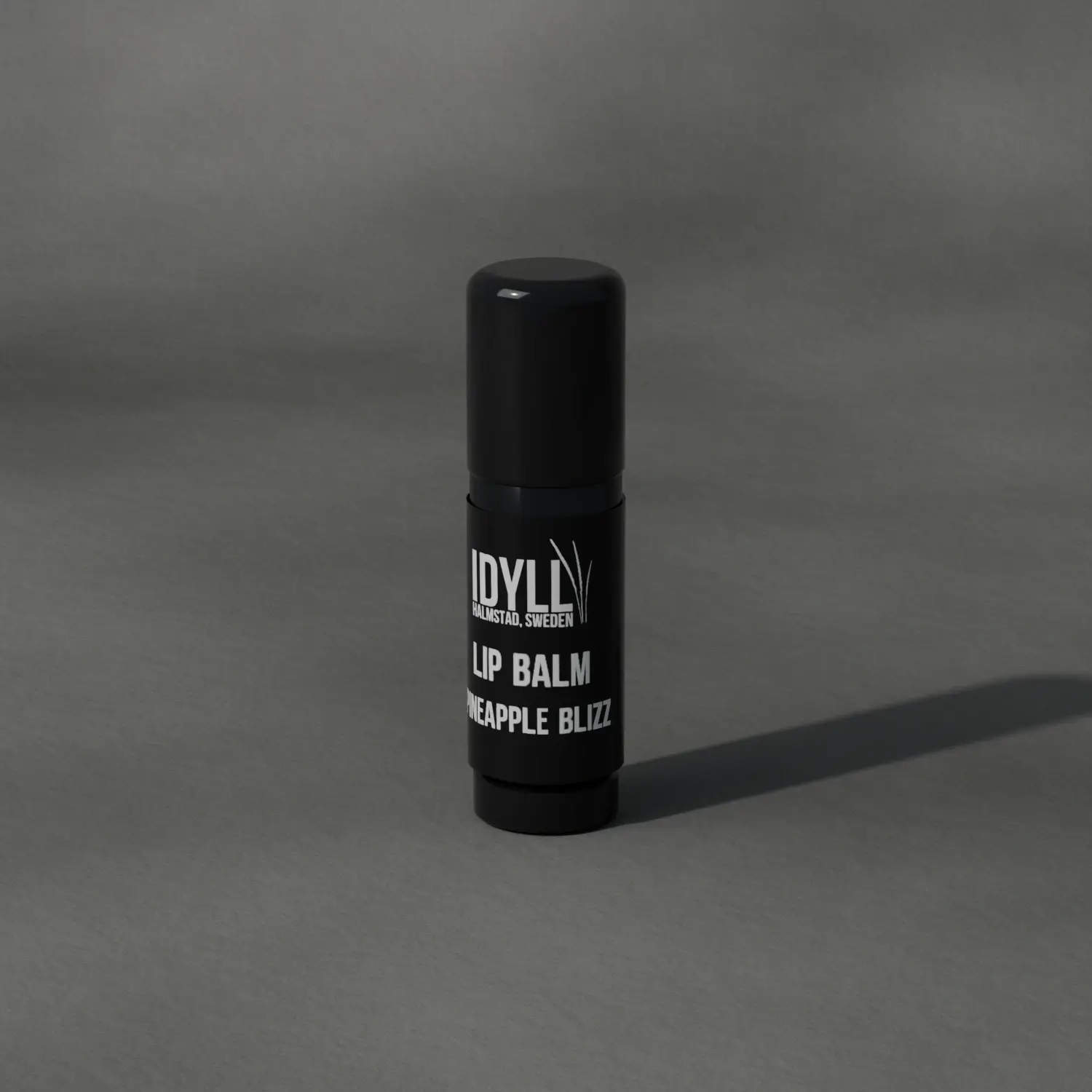 Natural Lip Balm Pineapple Blizz on stone, in daylight